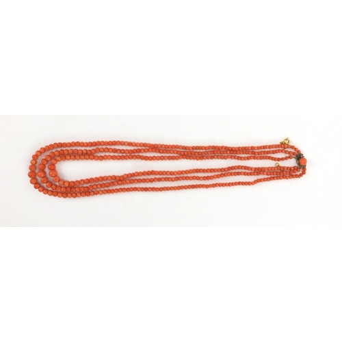 926 - Three row coral necklace and matching bracelet, the necklace 44cm long, approximate weight 59.5g