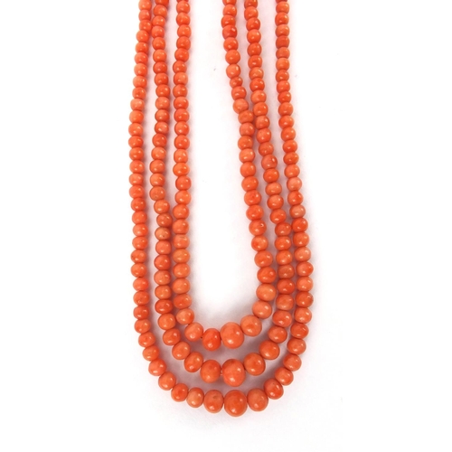 926 - Three row coral necklace and matching bracelet, the necklace 44cm long, approximate weight 59.5g