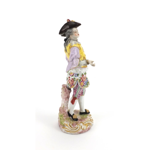 659 - Continental hand painted porcelain figure of a Dandy, blue cross sword marks to the base, 23cm high