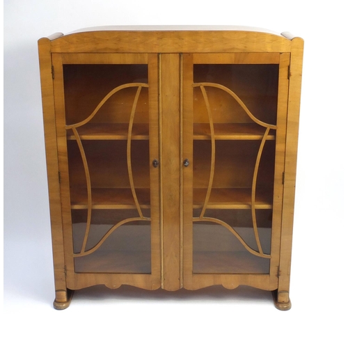 2034 - Art Deco walnut china cabinet fitted with a pair of glazed doors enclosing two shelves, 124cm high x... 