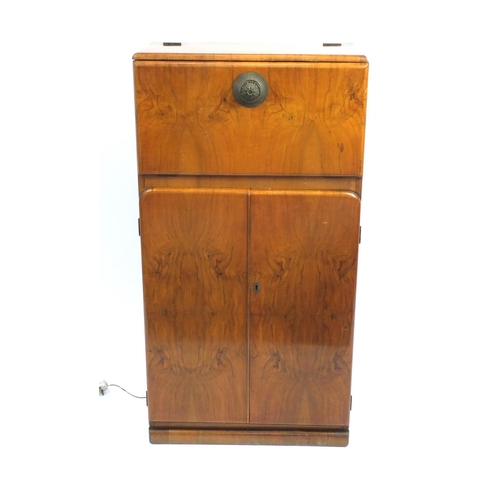 2064 - Art Deco walnut cocktail cabinet with mechanical action top, with mirrored interior above a pair of ... 