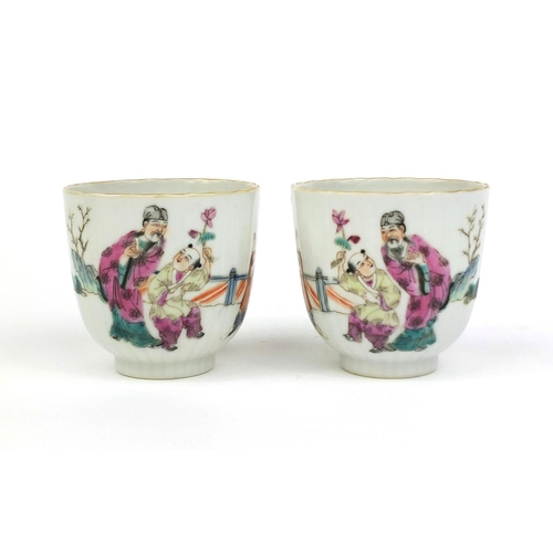 478 - Pair of Chinese porcelain tea cups, hand painted in the famille rose palette with court figures play... 