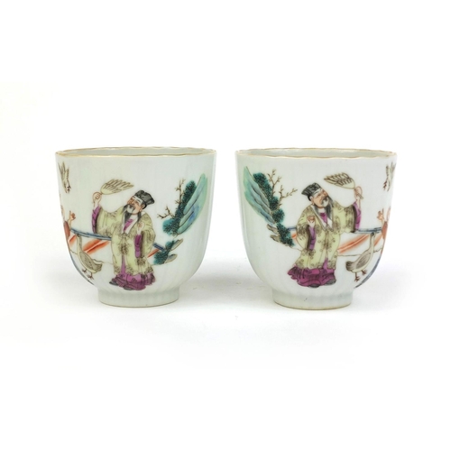 478 - Pair of Chinese porcelain tea cups, hand painted in the famille rose palette with court figures play... 