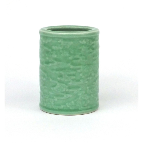 519 - Chinese celadon glazed cylindrical brush pot, decorated in low relief with a continuous band of clou... 