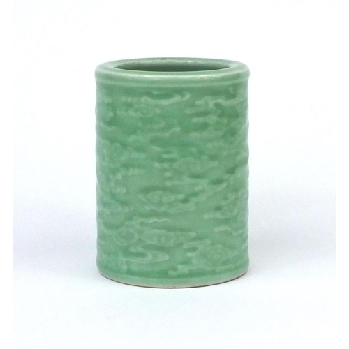 519 - Chinese celadon glazed cylindrical brush pot, decorated in low relief with a continuous band of clou... 