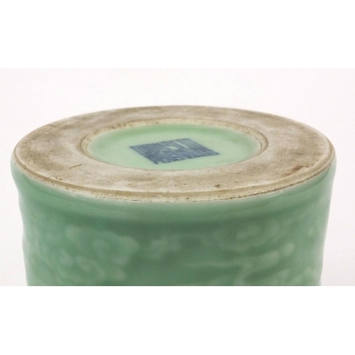 519 - Chinese celadon glazed cylindrical brush pot, decorated in low relief with a continuous band of clou... 