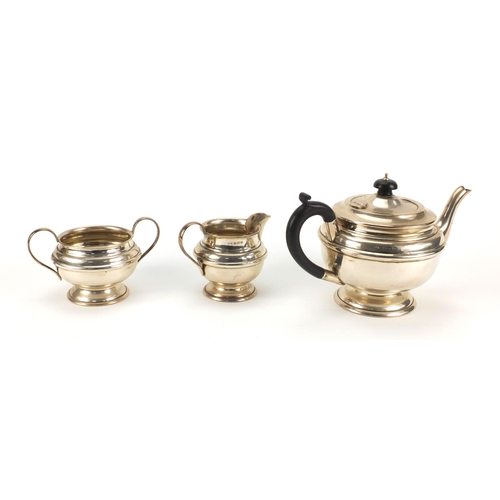 820 - Silver three piece tea service, W.F.M Birmingham 1936, the teapot 15cm high, approximate weight 691.... 