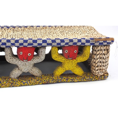 633 - 19th century Tribal interest Bamileke Cowrie shell and beadwork bed, 168cm in length