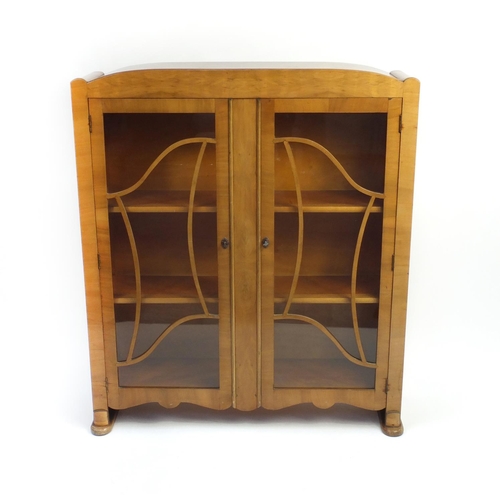 2034 - Art Deco walnut china cabinet fitted with a pair of glazed doors enclosing two shelves, 124cm high x... 