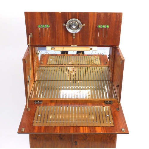 2064 - Art Deco walnut cocktail cabinet with mechanical action top, with mirrored interior above a pair of ... 