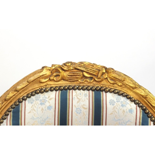 2012 - Pair of Louis XVI style gilt wood fauteuils with striped upholstery, 101cm high