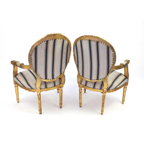 2012 - Pair of Louis XVI style gilt wood fauteuils with striped upholstery, 101cm high