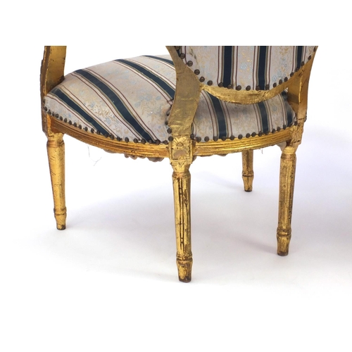 2012 - Pair of Louis XVI style gilt wood fauteuils with striped upholstery, 101cm high