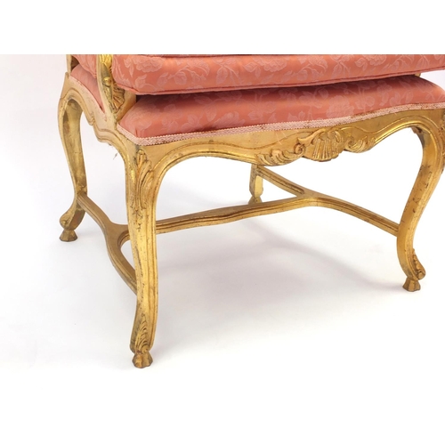 2026 - Gilt wood fauteuil, the toprail with carved shell motif, pink floral upholstery, 103cm high