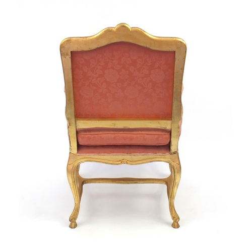 2026 - Gilt wood fauteuil, the toprail with carved shell motif, pink floral upholstery, 103cm high