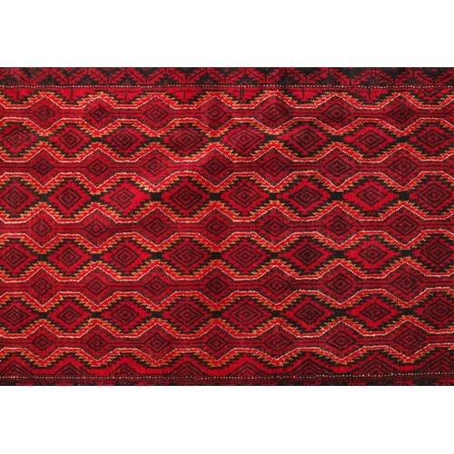 2056 - Rectangular Persian Baluchi rug with central field and borders having an all over geometric design t... 