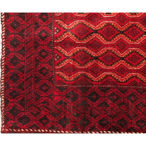 2056 - Rectangular Persian Baluchi rug with central field and borders having an all over geometric design t... 