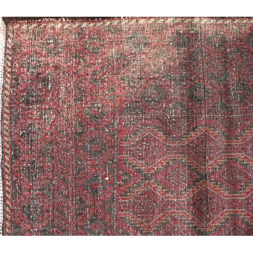 2056 - Rectangular Persian Baluchi rug with central field and borders having an all over geometric design t... 