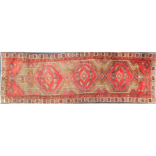 2061 - Rectangular Persian Arak carpet runner, having an all over geometric design onto a predominantly red... 