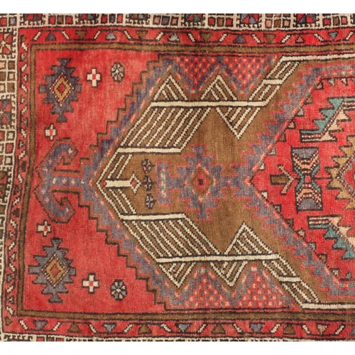 2061 - Rectangular Persian Arak carpet runner, having an all over geometric design onto a predominantly red... 