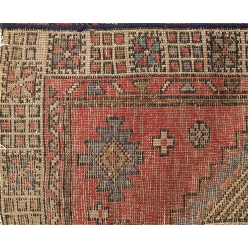 2061 - Rectangular Persian Arak carpet runner, having an all over geometric design onto a predominantly red... 