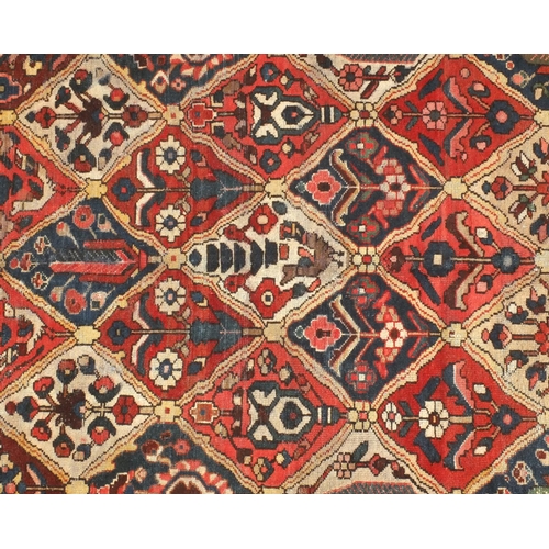 2039 - Rectangular Persian bakhtiari rug, the central field having all over floral motifs with cream girdle... 