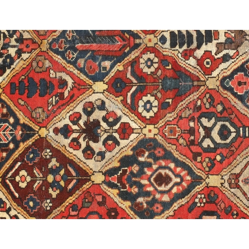 2039 - Rectangular Persian bakhtiari rug, the central field having all over floral motifs with cream girdle... 
