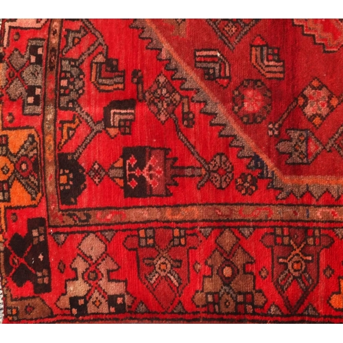 2067 - Rectangular Persian Hamadan rug, the central field and borders having all over floral motifs onto a ... 