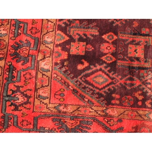 2045 - Rectangular Persian Hamadan rug, the central field having all over floral motifs, onto an red and pu... 