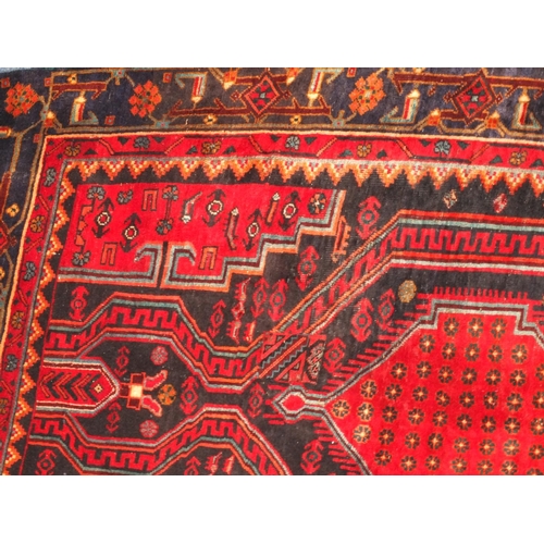 2010 - Rectangular Persian Kshan rug, having an all over floral and geometric design on to red dark ground,... 