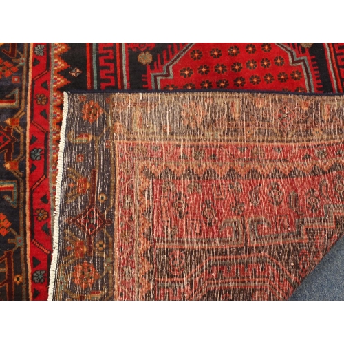 2010 - Rectangular Persian Kshan rug, having an all over floral and geometric design on to red dark ground,... 