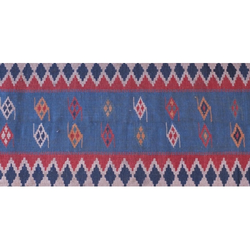 2088A - Antique rectangular Kilim carpet runner, having a geometric design on to a blue ground, 280cm x 85cm