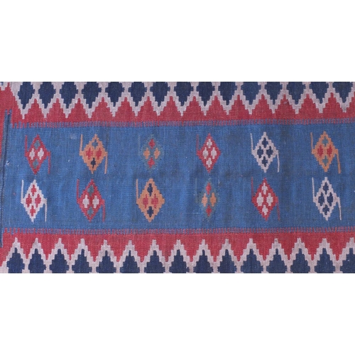 2088A - Antique rectangular Kilim carpet runner, having a geometric design on to a blue ground, 280cm x 85cm