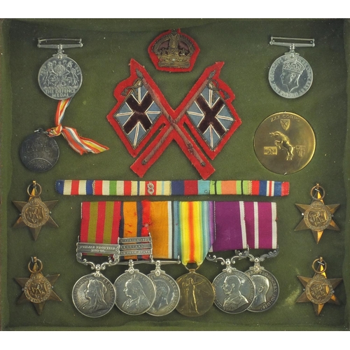 239 - British Military Victorian, World War I and World War II medals, with cloth insignia and brass badge... 