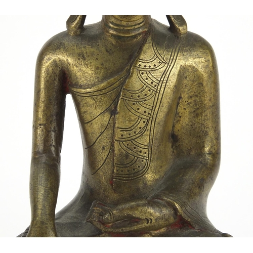 603 - Antique Thai bronze seated figure of Buddha, script to the reverse, 26cm high