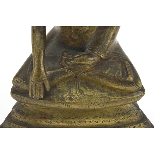 603 - Antique Thai bronze seated figure of Buddha, script to the reverse, 26cm high