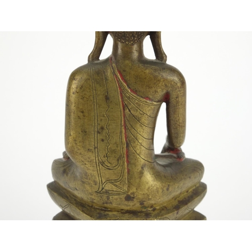 603 - Antique Thai bronze seated figure of Buddha, script to the reverse, 26cm high