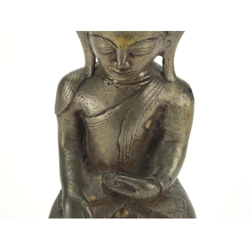 604 - Antique Thai patinated bronze seated figure of Buddha, script to the reverse, 18.5cm high