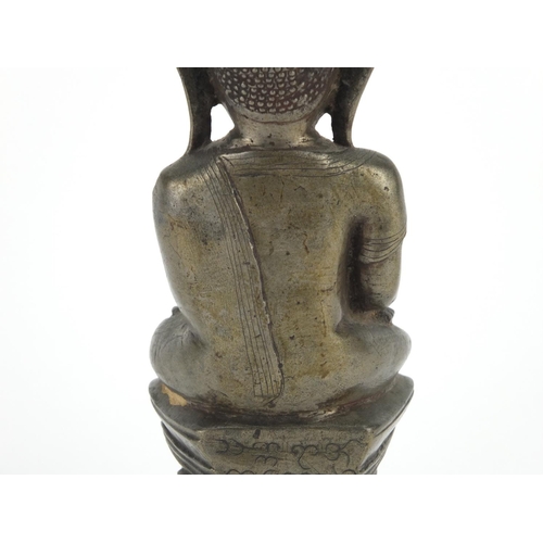 604 - Antique Thai patinated bronze seated figure of Buddha, script to the reverse, 18.5cm high