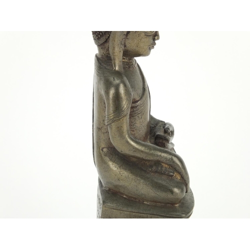 604 - Antique Thai patinated bronze seated figure of Buddha, script to the reverse, 18.5cm high