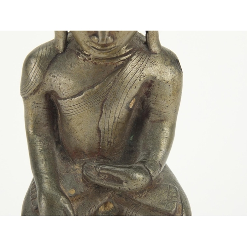 604 - Antique Thai patinated bronze seated figure of Buddha, script to the reverse, 18.5cm high