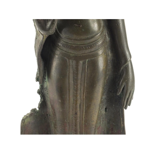 605 - Antique Thai patinated bronze standing figure of Buddha, on a later wooden stand, overall 61cm high