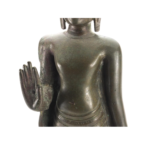 605 - Antique Thai patinated bronze standing figure of Buddha, on a later wooden stand, overall 61cm high