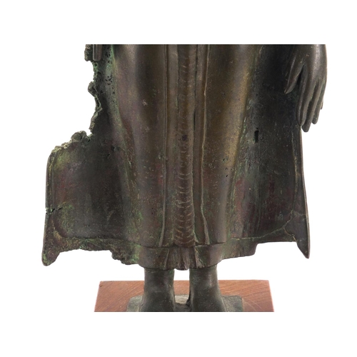 605 - Antique Thai patinated bronze standing figure of Buddha, on a later wooden stand, overall 61cm high