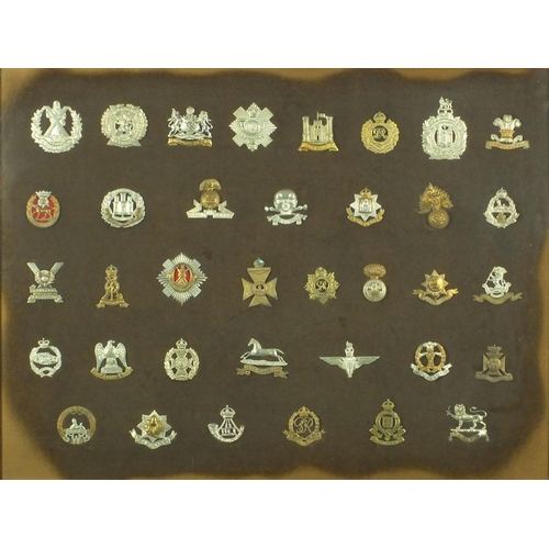 276 - Two framed displays of British Military cap badges including The Welch, Seventh Queen own Hussars, A... 