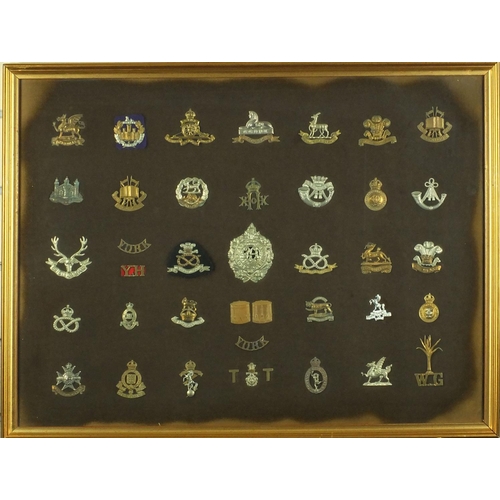 276 - Two framed displays of British Military cap badges including The Welch, Seventh Queen own Hussars, A... 