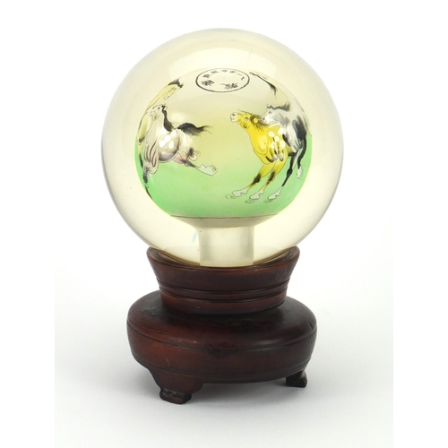 2223 - Chinese globular glass paperweight on hardwood revolving stand, the paperweight hand painted to the ... 