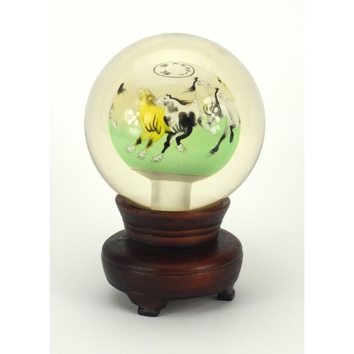 2223 - Chinese globular glass paperweight on hardwood revolving stand, the paperweight hand painted to the ... 