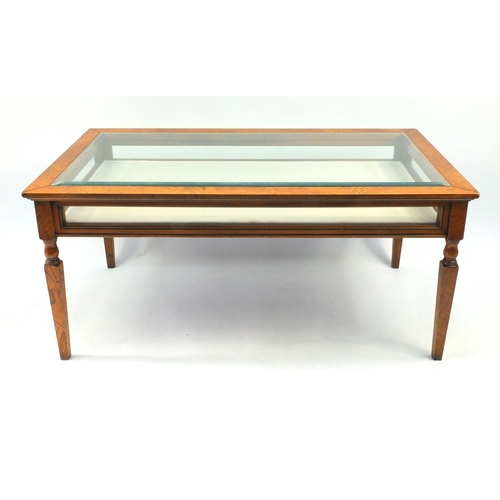 2019 - Walnut display table on turned and tapering legs, 55cm high x 120cm wide x 65cm deep