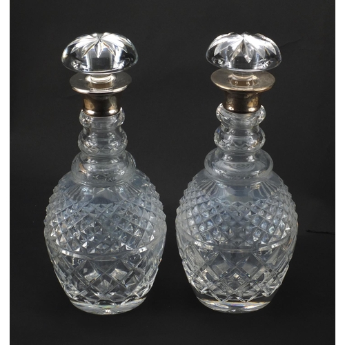 2188 - Pair of silver topped cut glass decanters, P & W London, each 30cm high